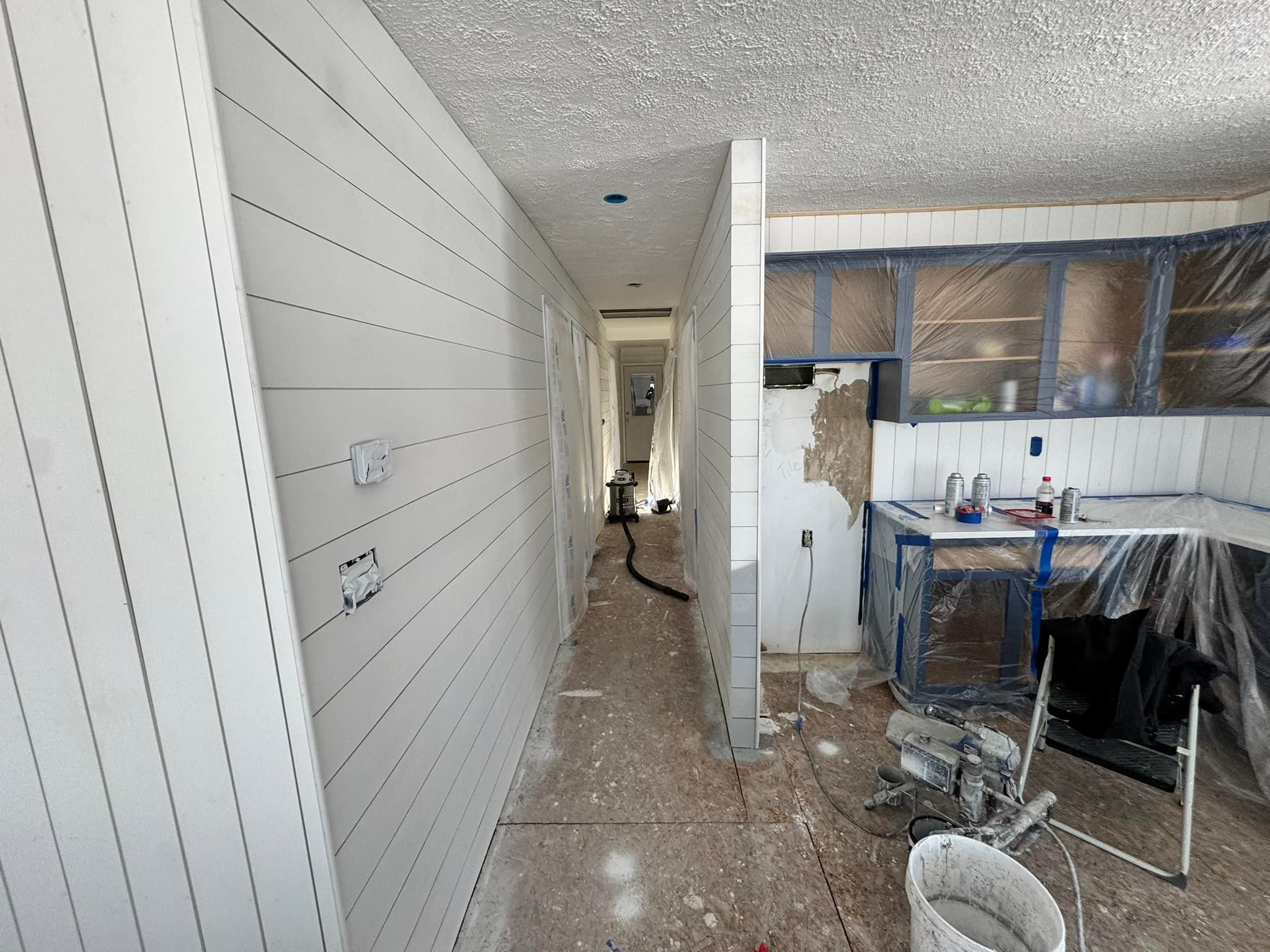 Interior trim and door installation in progress — cut materials staged for a lake house project